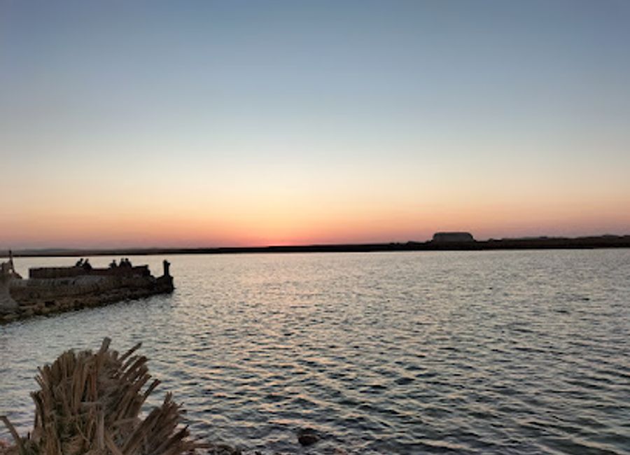 Escape to the tranquil beauty of Fitnas Spring in Siwa Oasis, where freshwater meets stunning sunsets and lush palm groves.