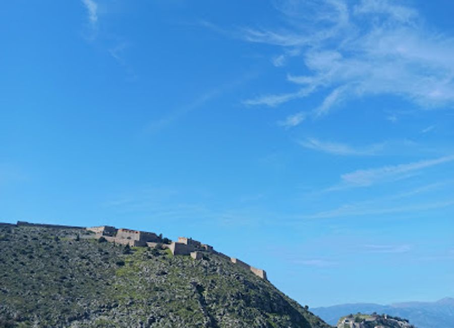 A solemn rock-carved lion commemorates Bavarian soldiers who died in Nafplio, offering a glimpse into 19th-century Greek-Bavarian relations.