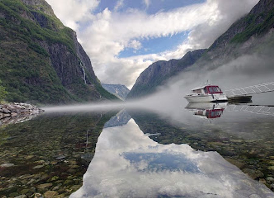 Explore Gudvangen Jetty, Norway's breathtaking scenic spot with stunning fjord views and nearby waterfalls in a tranquil natural setting.
