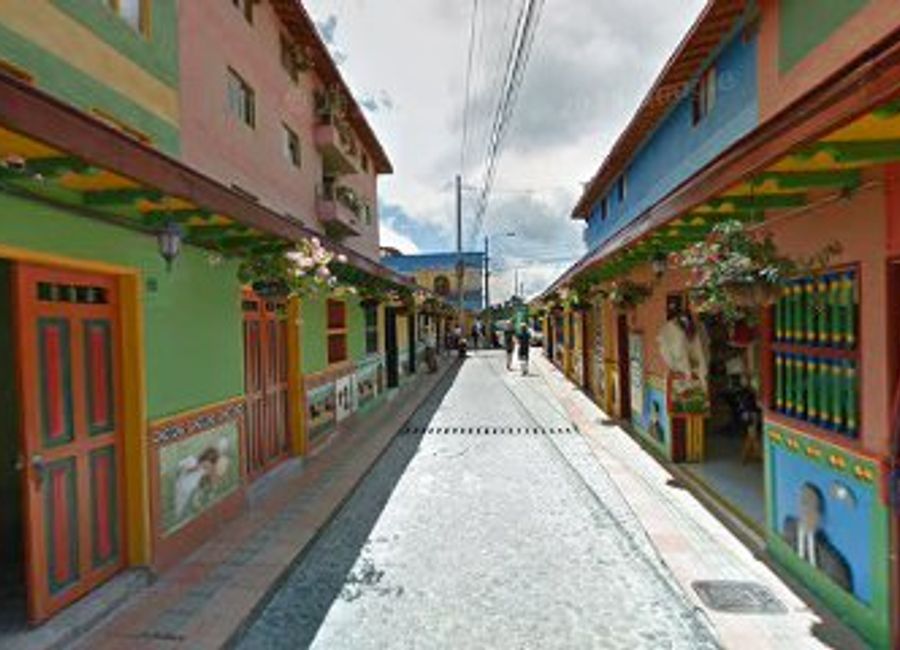 Discover the enchanting Calle de los Paraguas in Guatapé, Colombia, where vibrant umbrellas create a picturesque canopy perfect for unforgettable photos.
