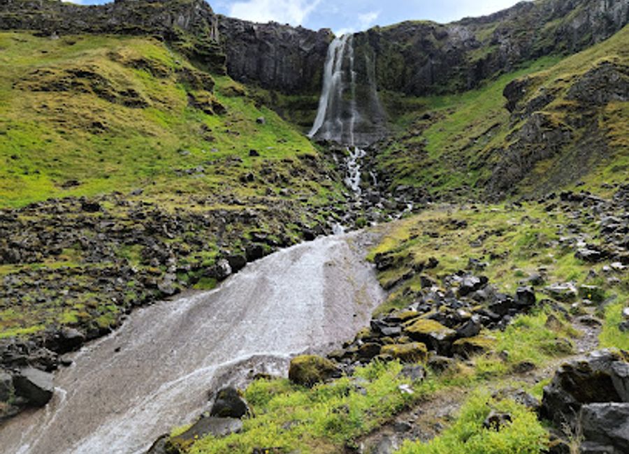 Discover the serene beauty of Bæjarfoss, a captivating waterfall in Iceland's Western Region, perfect for nature lovers and photographers alike.