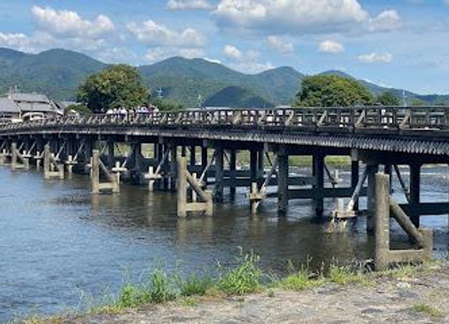 Discover the stunning Togetsukyo Bridge in Kyoto, where natural beauty meets rich cultural history amidst breathtaking landscapes.