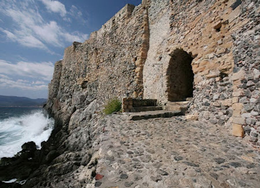 Swim in the shadow of history at Portello Beach, Monemvasia's unique cove within the ancient fortress walls, offering crystal-clear waters and stunning views.