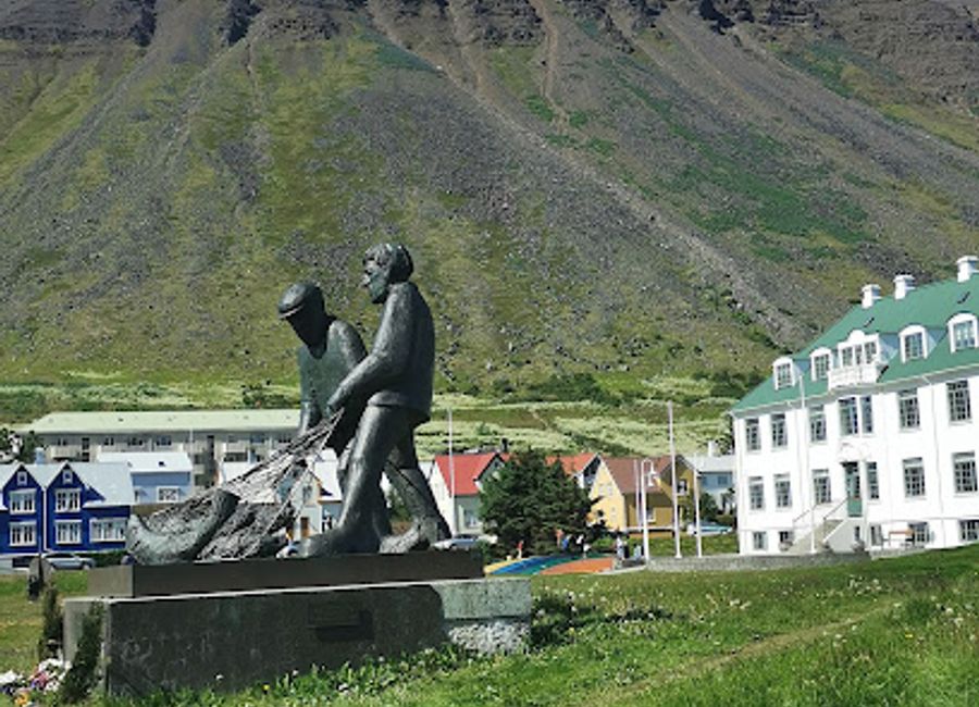 Discover the Fishermen's Monument in Ísafjörður, a breathtaking tribute to Iceland's fishing heritage surrounded by stunning fjords and rich history.