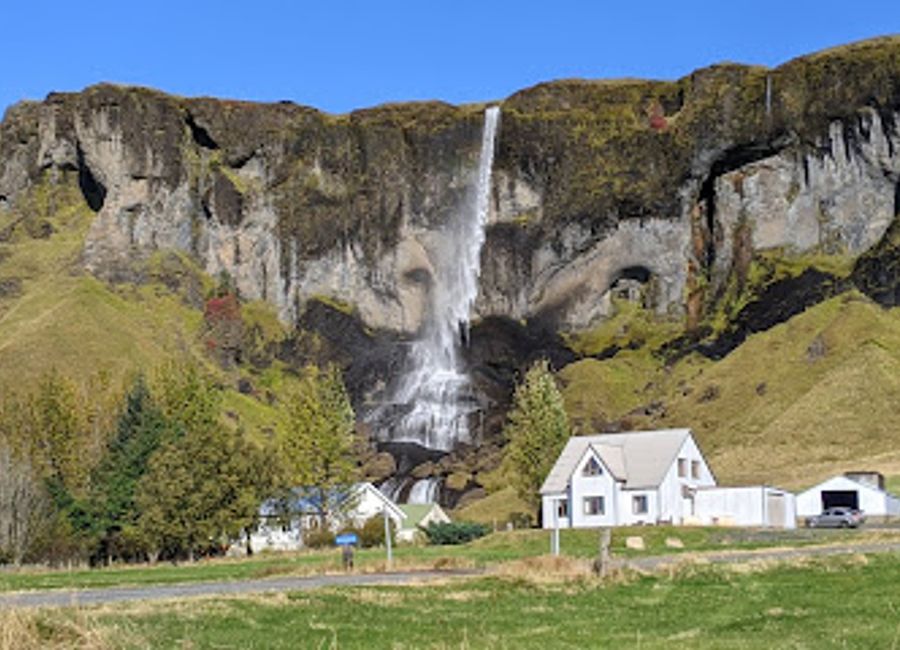 Discover the breathtaking beauty of Foss á Síðu, a serene waterfall surrounded by Iceland's stunning landscapes, perfect for nature lovers and photographers.