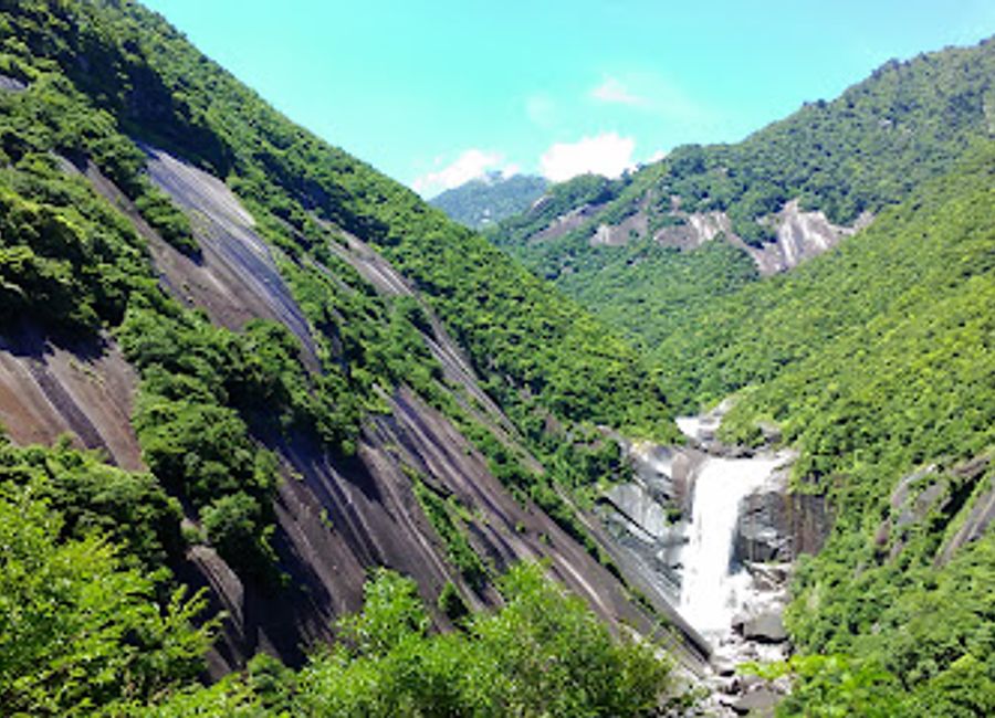 Explore the enchanting beauty of Senpiro Falls in Yakushima, where nature's splendor meets serene tranquility amidst lush greenery.