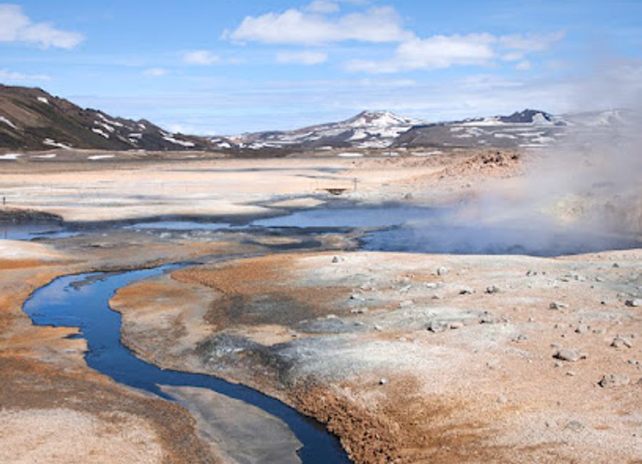 Discover the mesmerizing geothermal wonders of Hverir, where bubbling mud pots and steaming fumaroles create a unique Icelandic landscape.