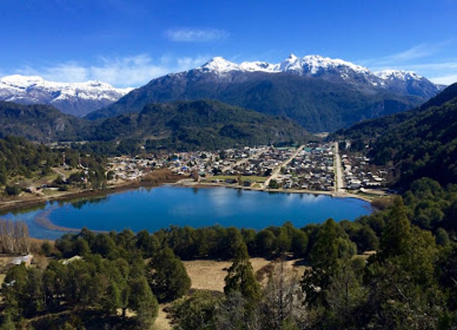 Discover the serene beauty of Laguna Espejo, a tranquil lake surrounded by majestic mountains in Futaleufú, Los Lagos, Chile.