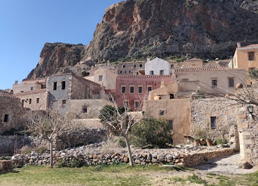 A historical cannon in Monemvasia's central square, a reminder of the town's strategic past and stunning Aegean Sea views.