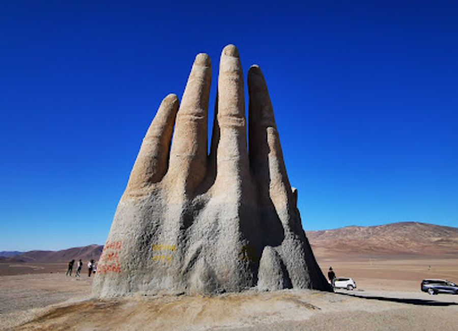 Explore the Hand of the Desert, a stunning sculpture in Antofagasta, Chile, blending art and nature in a breathtaking desert landscape.