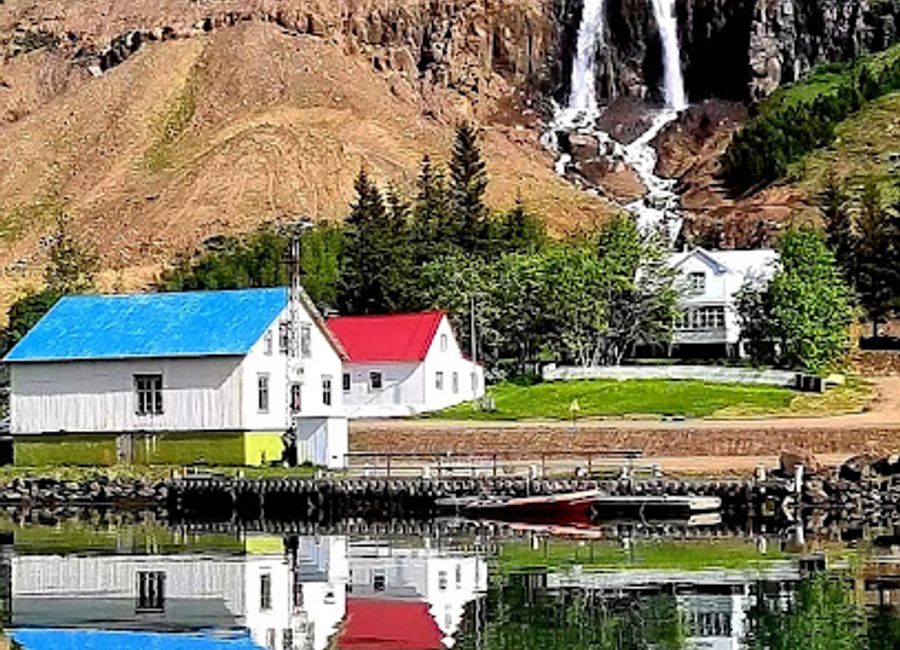 Experience the breathtaking beauty of Búðareyrarfoss, an enchanting waterfall in Seyðisfjörður, Iceland, surrounded by stunning landscapes.