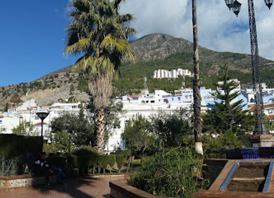 Discover the tranquility of Plaza Mohammed V, a serene park in Chefchaouen surrounded by stunning blue buildings and vibrant local culture.