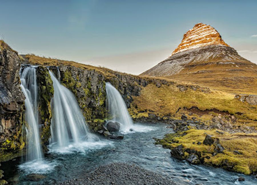 Experience the breathtaking beauty of Kirkjufellsfossar, an iconic waterfall surrounded by stunning landscapes in Iceland.