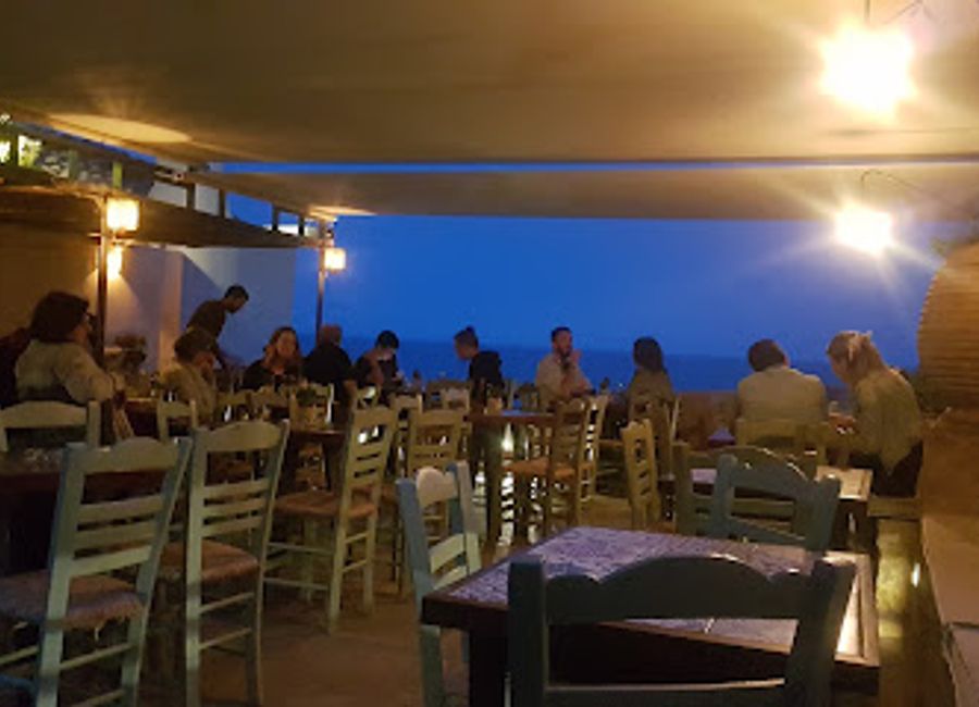 Experience the vibrant atmosphere of Enetiko Cafe & Cocktail Bar in Monemvasia, where delightful drinks and stunning views await.