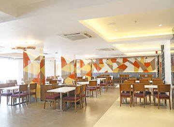 india/rajkot/restaurant/the-coconut-groove-multi-cuisine-restaurant-by-patria-suites