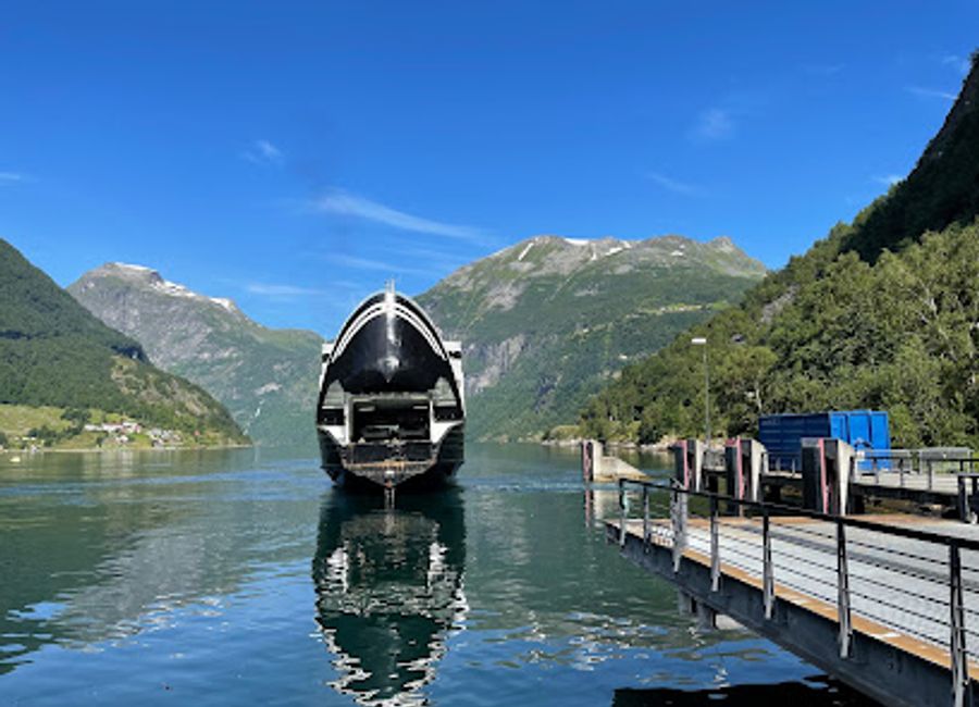 Experience breathtaking views at Geiranger Brygge while enjoying exquisite drinks in the heart of Norway's stunning fjord landscape.