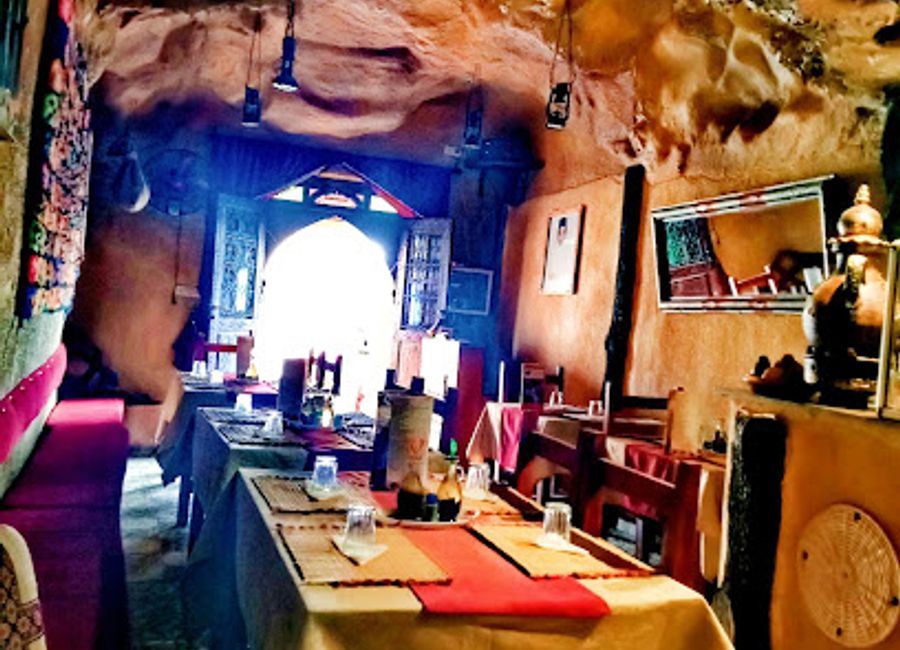 Savor traditional Moroccan dishes amidst stunning desert landscapes at La Grotte Dunes Restaurant in Merzouga.