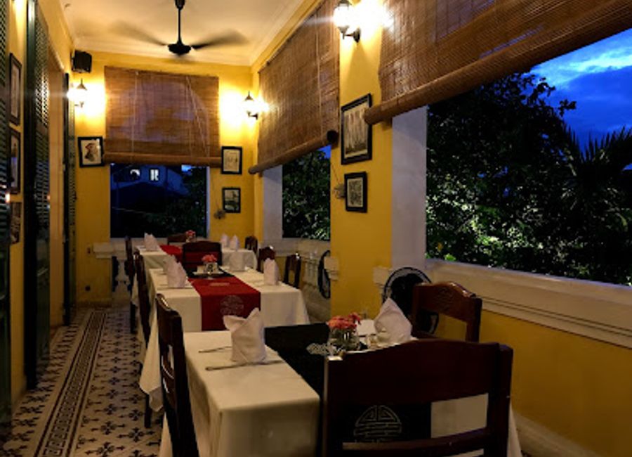 Discover authentic Vietnamese cuisine in a tranquil garden setting at Les Jardins de la Carambole in Huế.