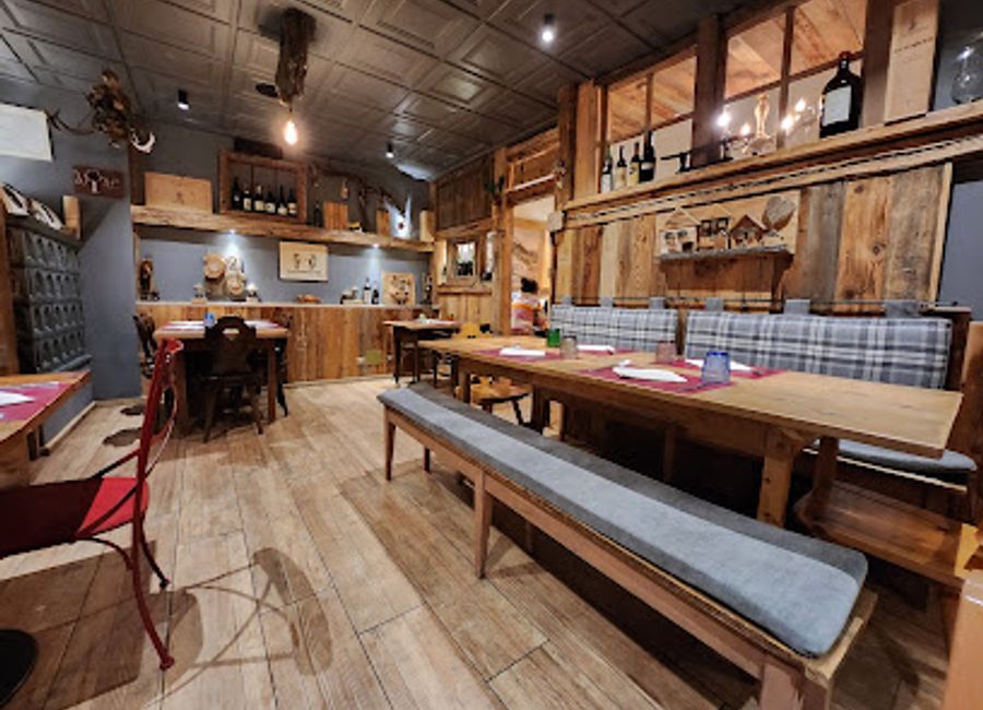 Experience authentic Trentino cuisine at Ostaria DaSté in Campitello di Fassa, where every meal is a celebration of local flavors amidst stunning mountain views.