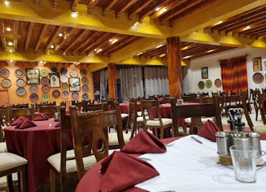 Experience authentic Moroccan cuisine at Sky Restaurant in Merzouga, where family-friendly dining meets breathtaking Sahara Desert views.