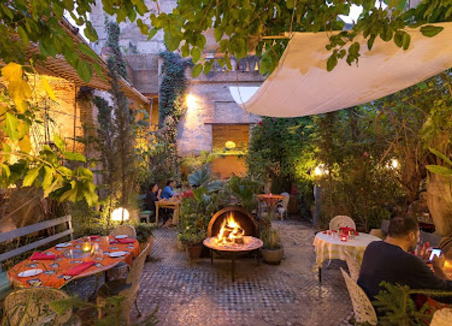 Experience authentic Moroccan flavors in an enchanting garden setting at The Ruined Garden in Fes.