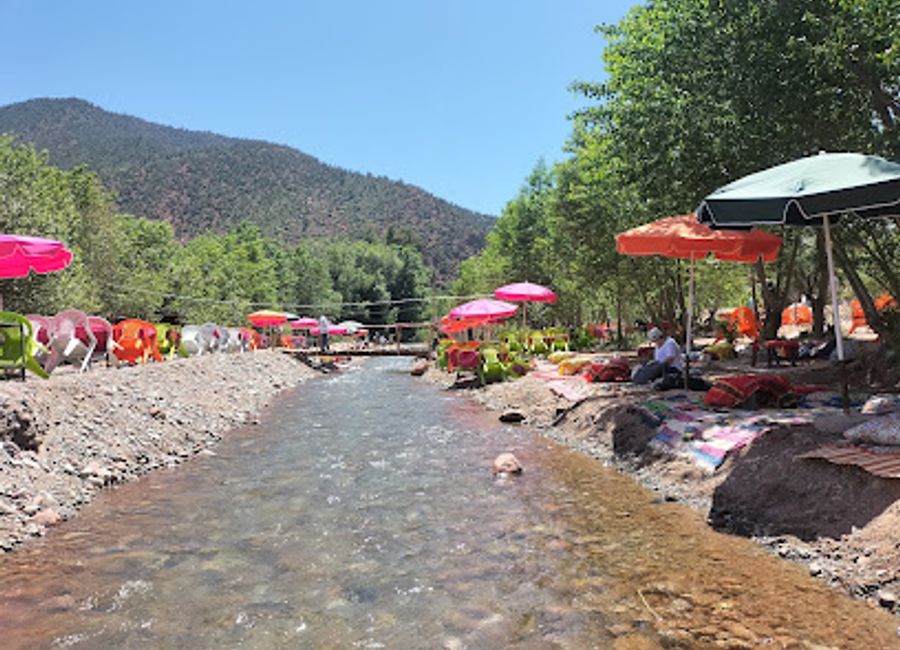 Experience authentic Moroccan cuisine in a serene riverside setting at Restaurant Timalizen in Ourika Valley.