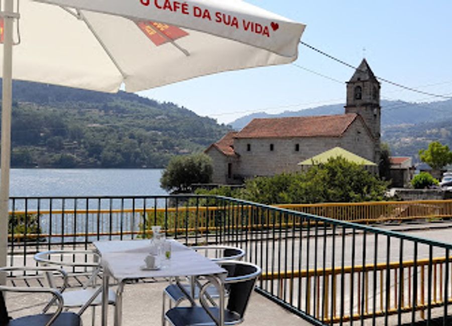 Experience authentic Portuguese cuisine with stunning river views at Restaurante Da Azenha in Ribadouro.