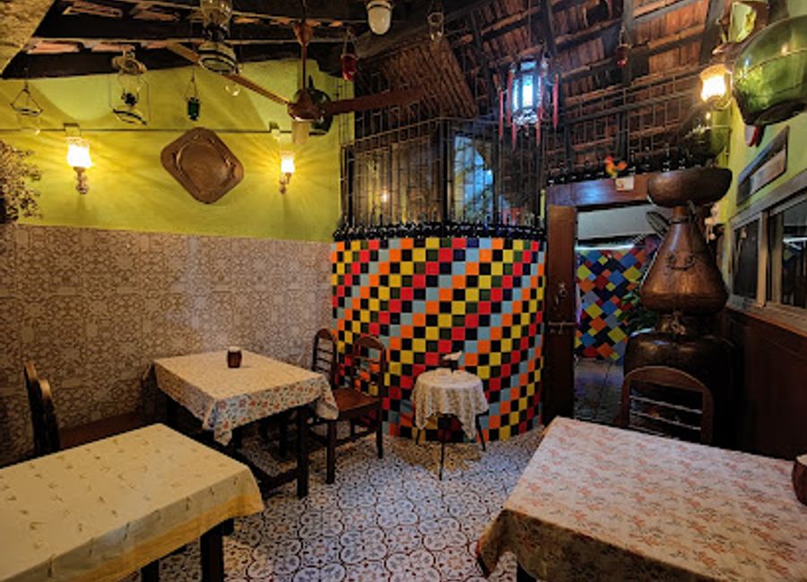 Experience authentic Goan cuisine at Bhatti Village Family Bar & Restaurant – a family-friendly spot serving fresh seafood in a vibrant setting.