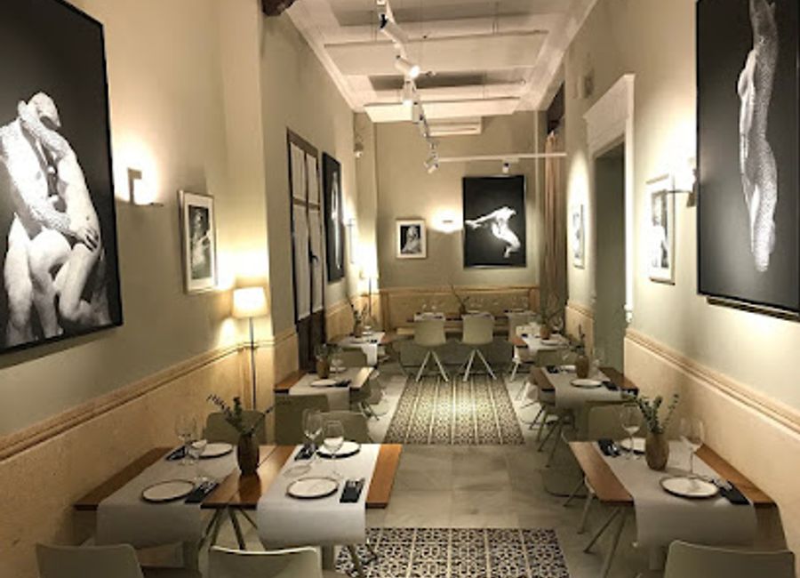 Experience authentic Andalusian flavors at El Pasaje Santa María la Blanca in Seville's historic Casco Antiguo district.