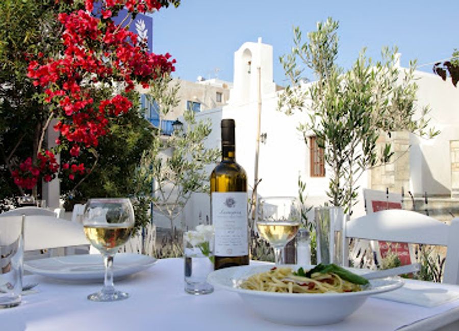 Experience authentic Greek flavors in a tranquil garden setting at Open Garden Restaurant in Naousa.