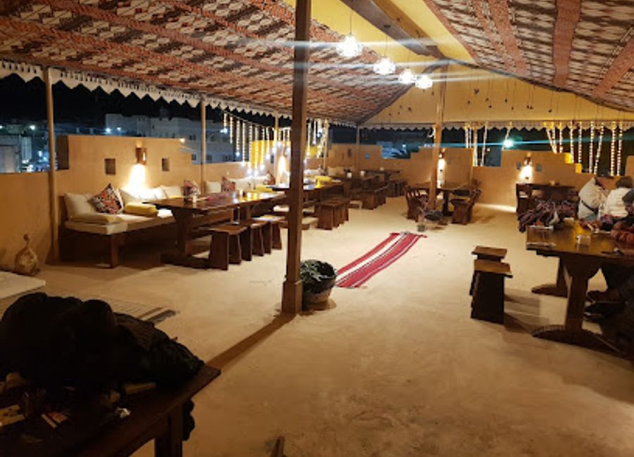 Experience authentic Bedouin cuisine and stunning sunset views at Bedouin Roof Restaurant in Siwa.