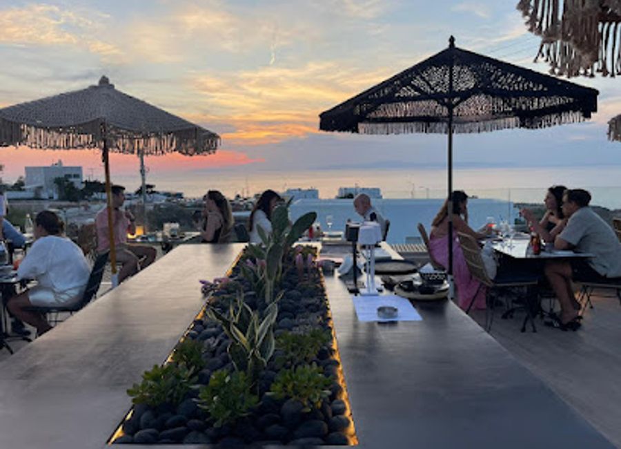 Experience breathtaking sunsets and delightful Greek cuisine at KooKoo Bar Restaurant in Oia, Santorini.