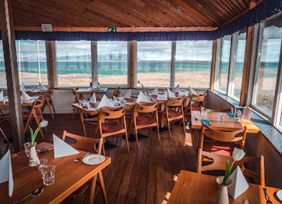 Experience exquisite seafood and Scandinavian cuisine at Hafið Bláa Restaurant, where stunning river views enhance every meal.