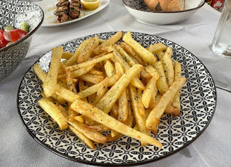 Experience authentic Greek barbecue at Proastio Taverna Grill—where tradition meets flavor in a charming setting.