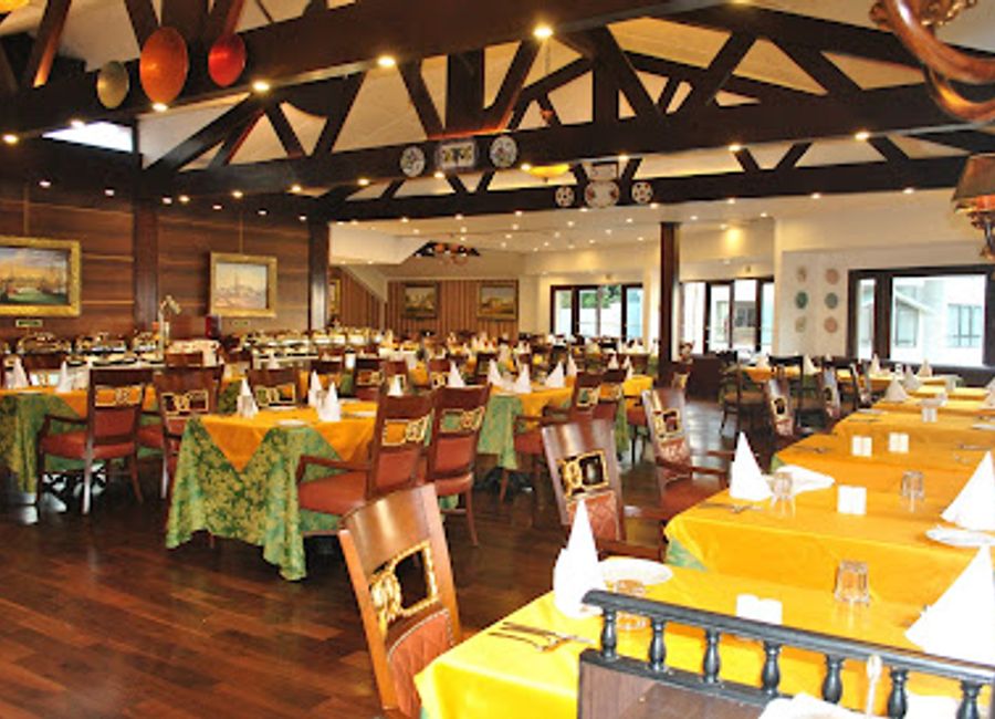 Experience the flavors of India and China at Magnolia Restaurant in Darjeeling's Mayfair Hotel amidst breathtaking mountain views.