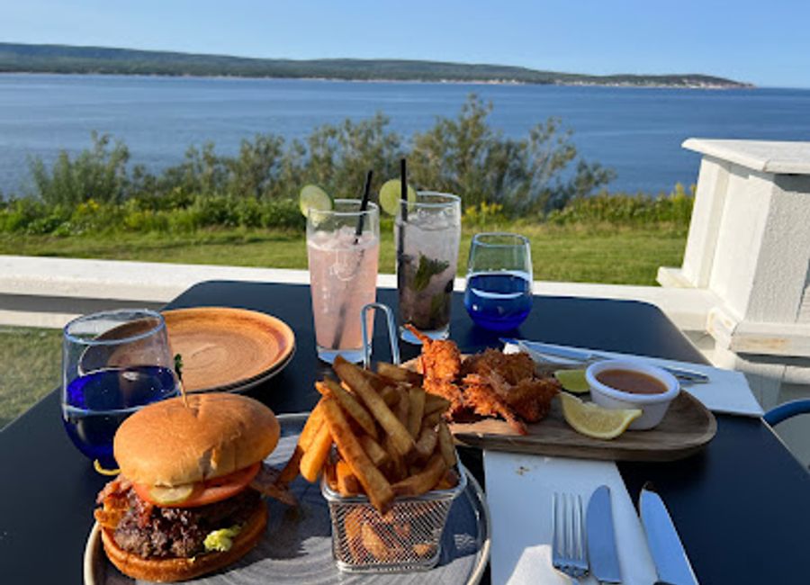 Discover exquisite Western cuisine at The Arduaine Restaurant and Lodge in scenic Ingonish Beach, Nova Scotia – where culinary delight meets stunning views.