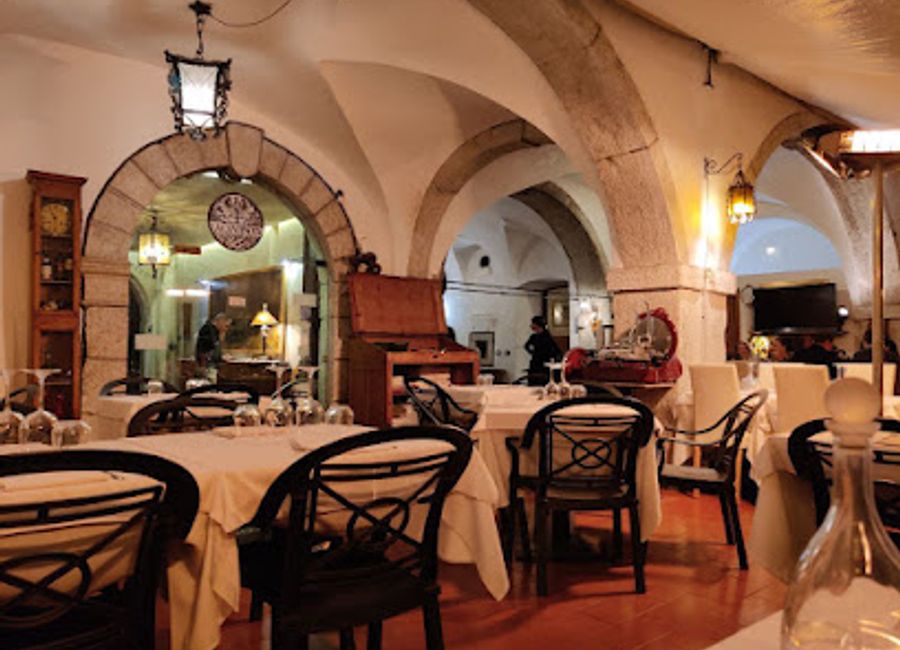 Experience authentic Italian cuisine amidst a charming garden at Ristorante La Cantinota in Trento—where culinary delights meet vibrant nightlife.