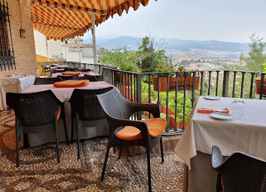 Experience authentic Andalusian cuisine while enjoying breathtaking views of Granada at Restaurante Mirador Carmen de San Miguel.