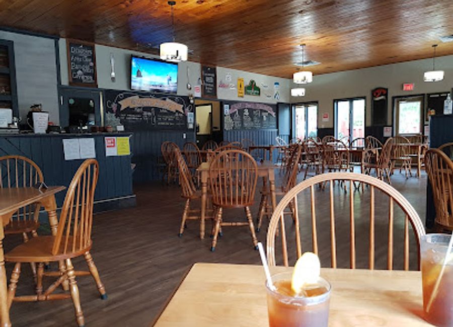 Discover Coastal Restaurant & Pub: A delightful blend of seafood and burgers with stunning ocean views along Nova Scotia's scenic Cabot Trail.