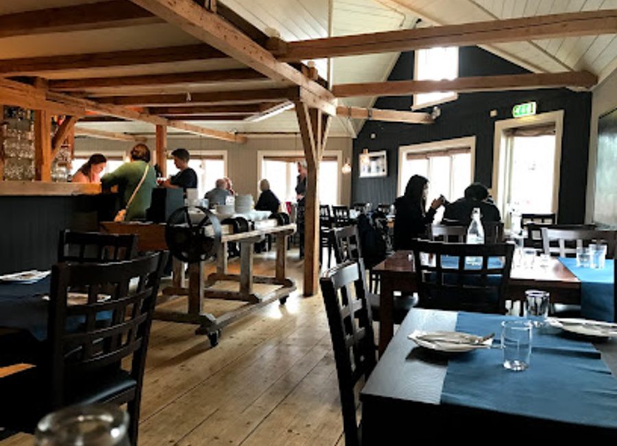 Experience authentic Norwegian cuisine with stunning waterfront views at Maren Anna in Sørvågen.