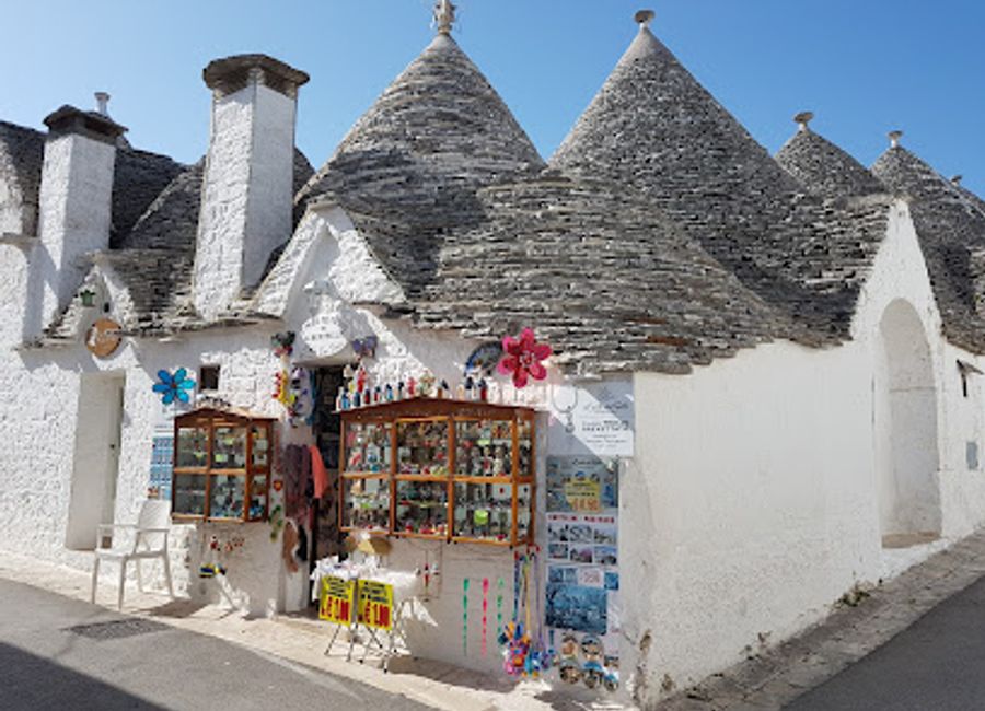 Explore The Smallest Trulli of Alberobello, a quaint artisan shop filled with unique souvenirs and traditional crafts that embody Puglia's rich heritage.