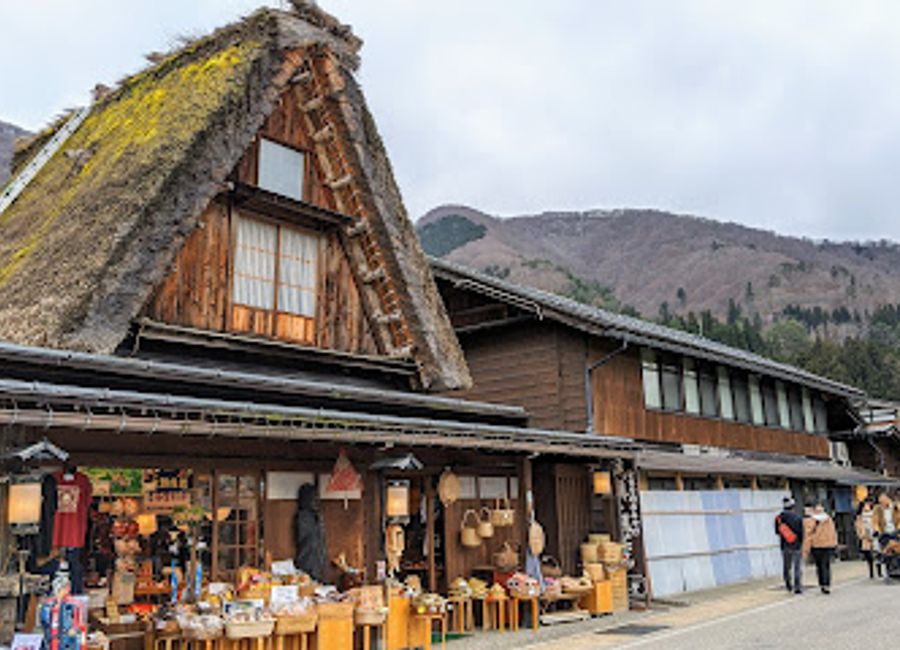 Explore Mamekichi Honpo Shirakawago, a quaint souvenir store in Shirakawa-go, showcasing local crafts and delicious treats steeped in tradition.