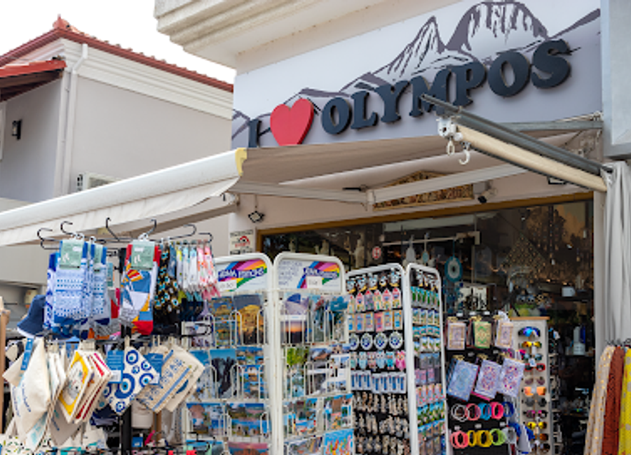 Explore Votsi's souvenir shop for unique local crafts and essential travel tips while enjoying the stunning backdrop of Mount Olympus.