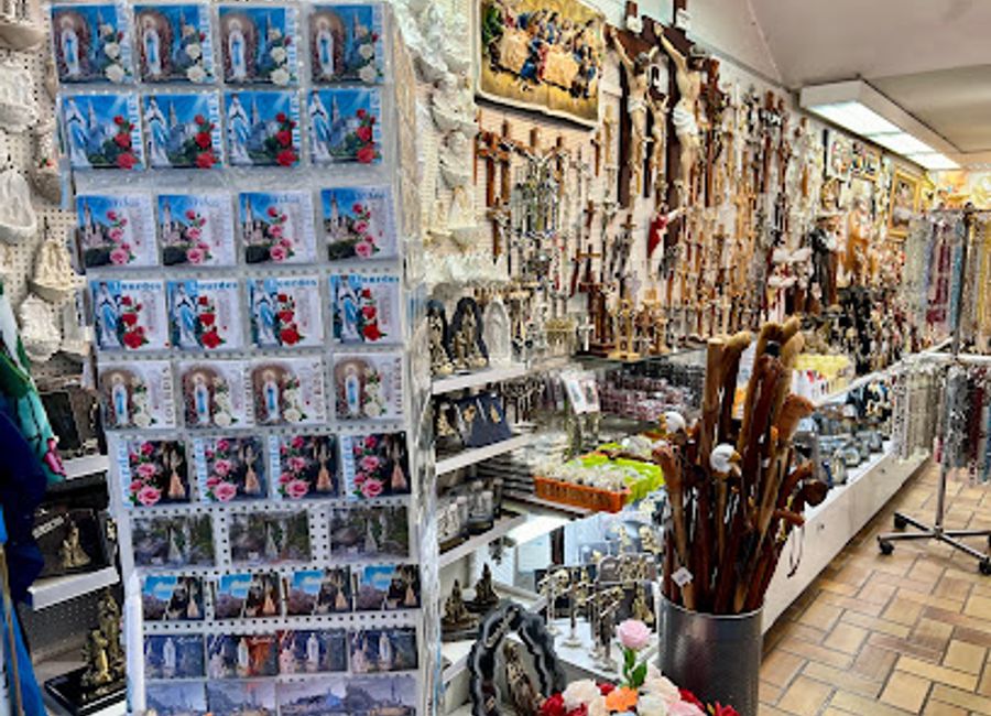 Discover unique souvenirs and religious artifacts at Boutique Sainte Anne, a charming gift shop in the heart of Lourdes, France.